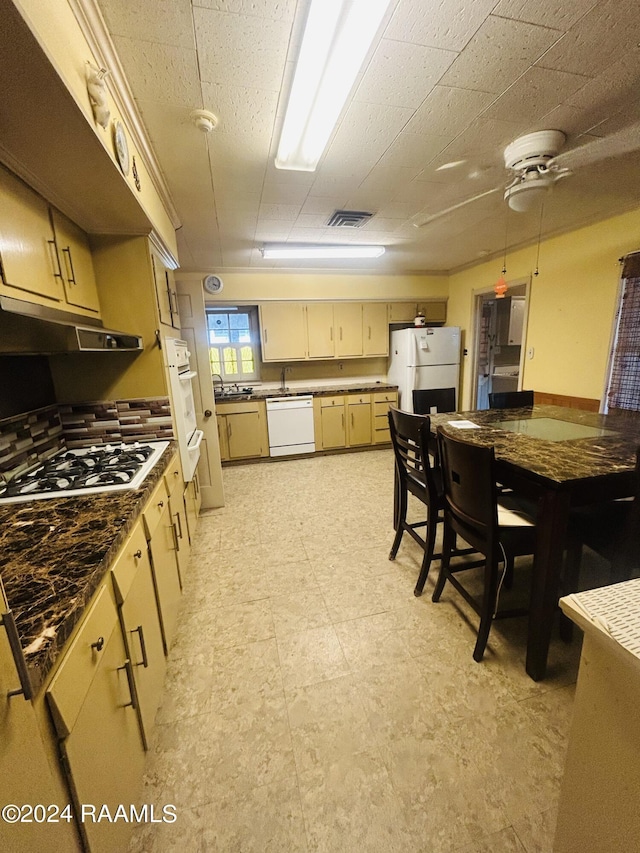 1519 Jasmine Dr, Opelousas, LA 70570 - kitchen featuring white appliances, a ceiling fan, under cabinet range hood, a sink, and light floors