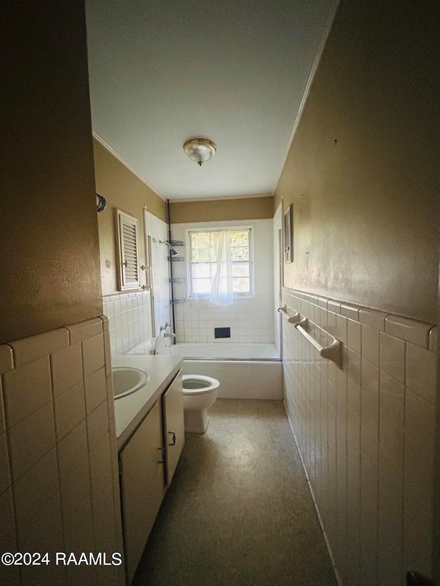 full bathroom with vanity, tiled shower / bath, toilet, ornamental molding, and tile walls