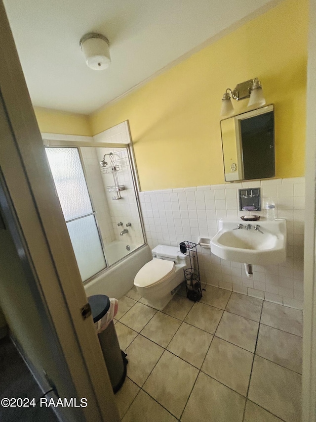 1519 Jasmine Dr, Opelousas, LA 70570 - bathroom featuring toilet, tile patterned flooring, enclosed tub / shower combo, and a sink