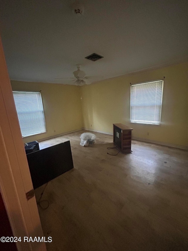 carpeted spare room with plenty of natural light and ceiling fan