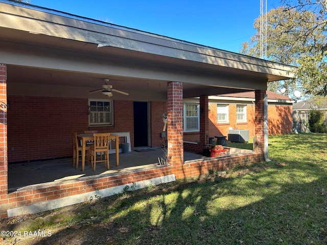 rear view of house featuring a yard, ceiling fan, and a patio area