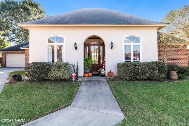 view of front facade with a front yard and a garage