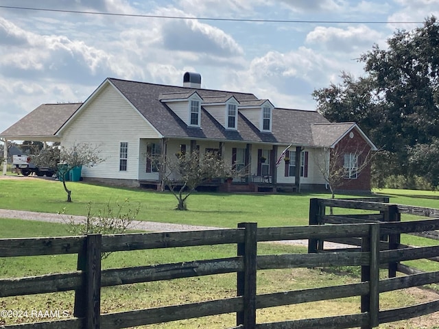 cape cod house with a front yard