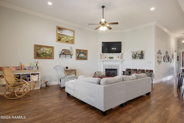 living room with ornamental molding, ceiling fan, and dark wood-type flooring