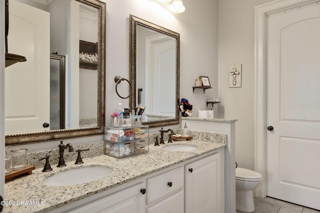 bathroom featuring tile patterned flooring, vanity, and toilet