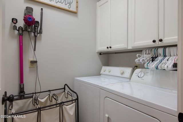 laundry area with cabinets and washing machine and dryer