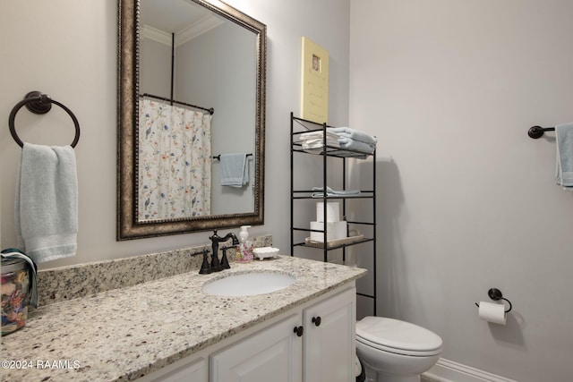 bathroom featuring vanity, toilet, and crown molding