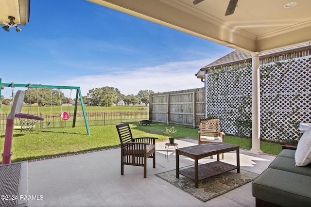 view of patio with an outdoor living space, a playground, and ceiling fan