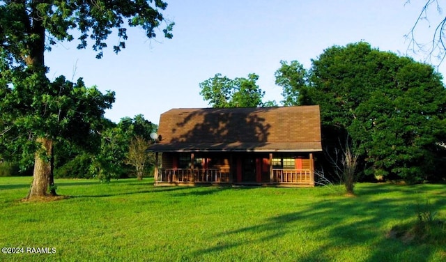 rear view of property with a lawn