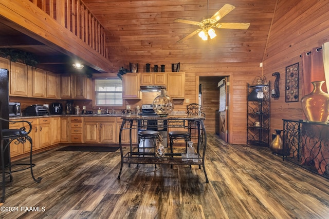 kitchen featuring ceiling fan, wood walls, high vaulted ceiling, and dark hardwood / wood-style floors