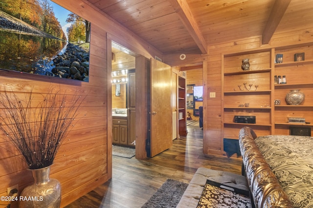 interior space with beamed ceiling, dark hardwood / wood-style floors, wood walls, and wood ceiling