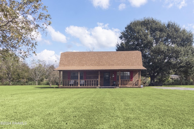 log cabin with a front yard and a porch