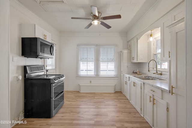 kitchen featuring stainless steel appliances, a wealth of natural light, and white cabinetry