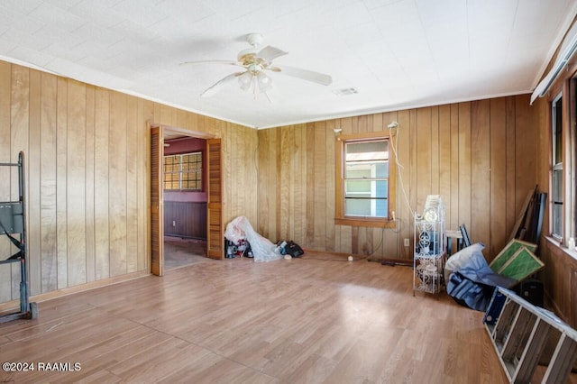 miscellaneous room featuring hardwood / wood-style flooring, wooden walls, and ceiling fan