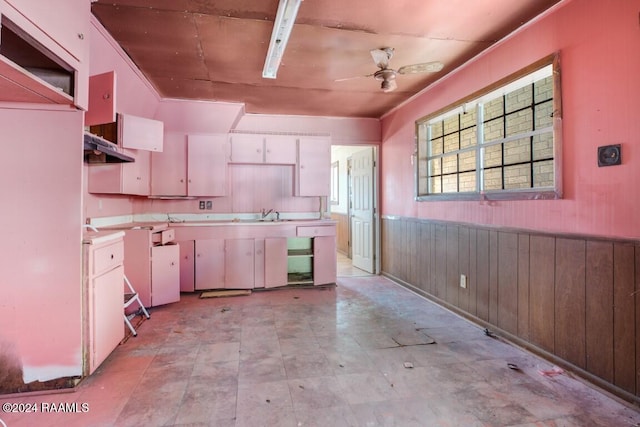 kitchen featuring white cabinetry, white range, sink, and ceiling fan