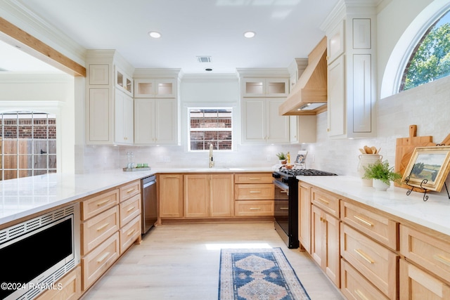 kitchen with crown molding, appliances with stainless steel finishes, and plenty of natural light