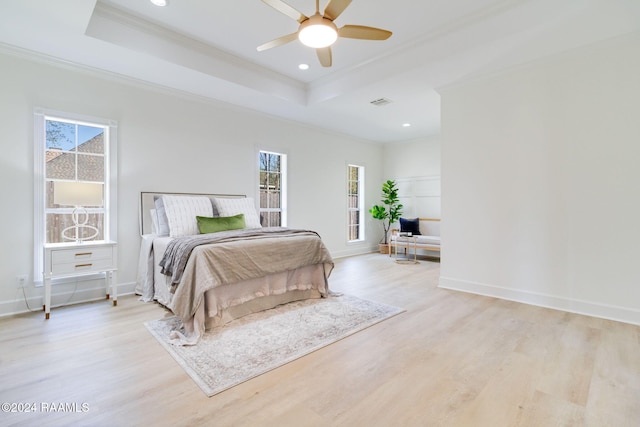 bedroom featuring multiple windows, ornamental molding, light wood-type flooring, and ceiling fan