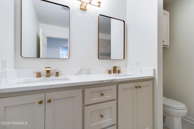 bathroom featuring vanity, toilet, and tile patterned floors