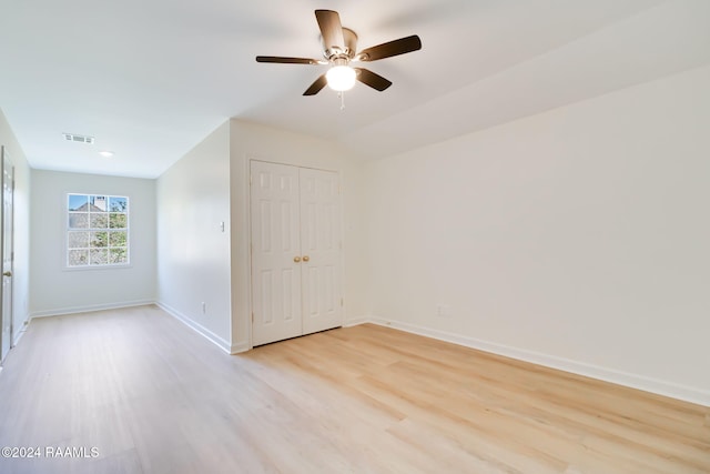 empty room with ceiling fan and light wood-type flooring