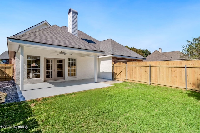 back of property featuring a yard, ceiling fan, and a patio