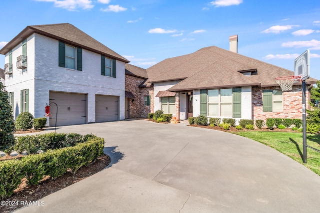 102 English Gardens Pkwy, Lafayette, LA 70503 - view of front of property with concrete driveway, roof with shingles, a garage, and brick siding