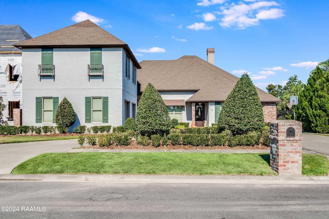 102 English Gardens Pkwy, Lafayette, LA 70503 - view of front facade featuring roof with shingles, a front lawn, and brick siding