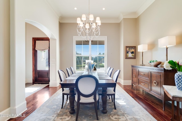 dining area featuring ornamental molding, a chandelier, and dark hardwood / wood-style floors