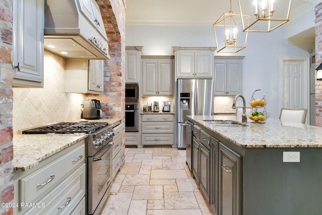 kitchen with an island with sink, sink, exhaust hood, gray cabinets, and appliances with stainless steel finishes