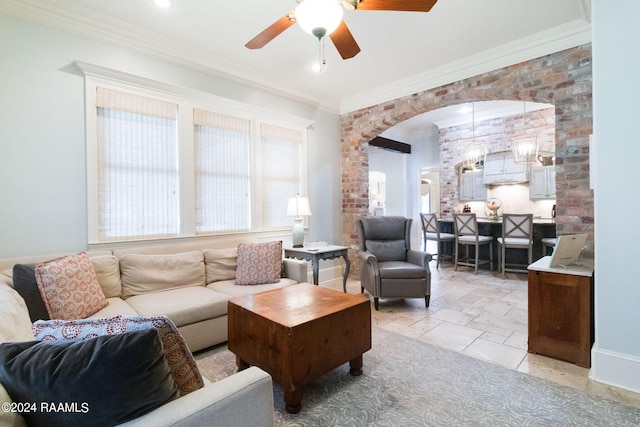 living room with crown molding and ceiling fan