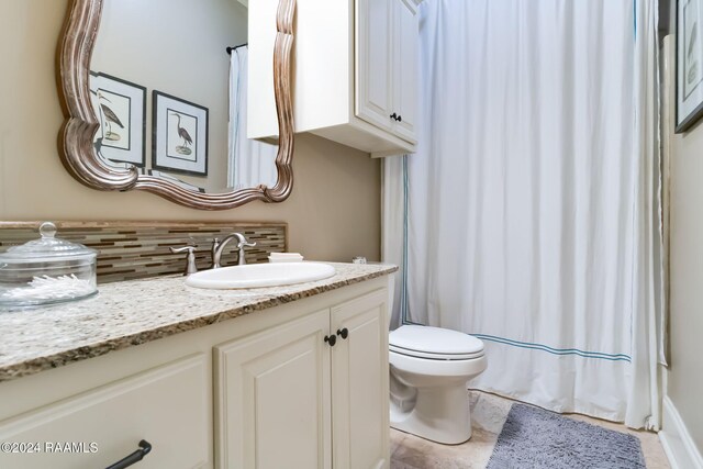 bathroom featuring vanity, toilet, tasteful backsplash, tile patterned flooring, and a shower with shower curtain