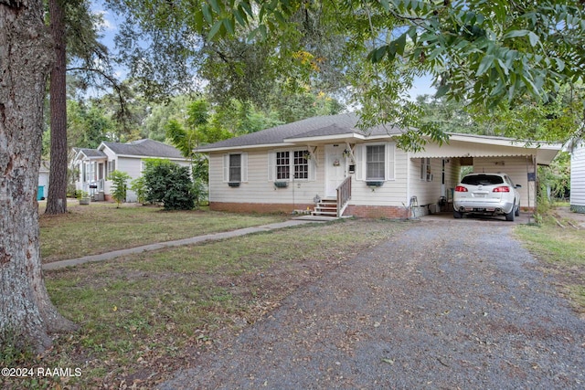 ranch-style house with a carport and a front yard