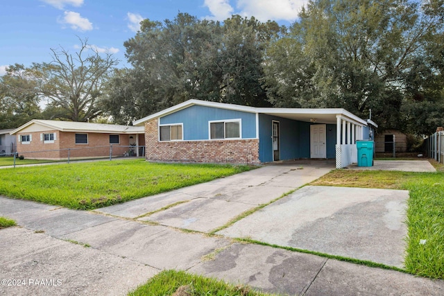 single story home featuring a carport and a front lawn