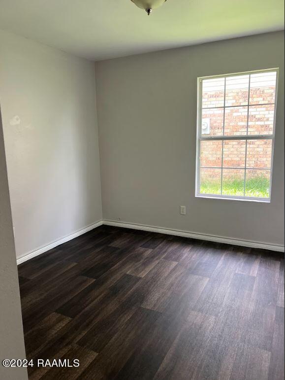 unfurnished room featuring dark hardwood / wood-style flooring