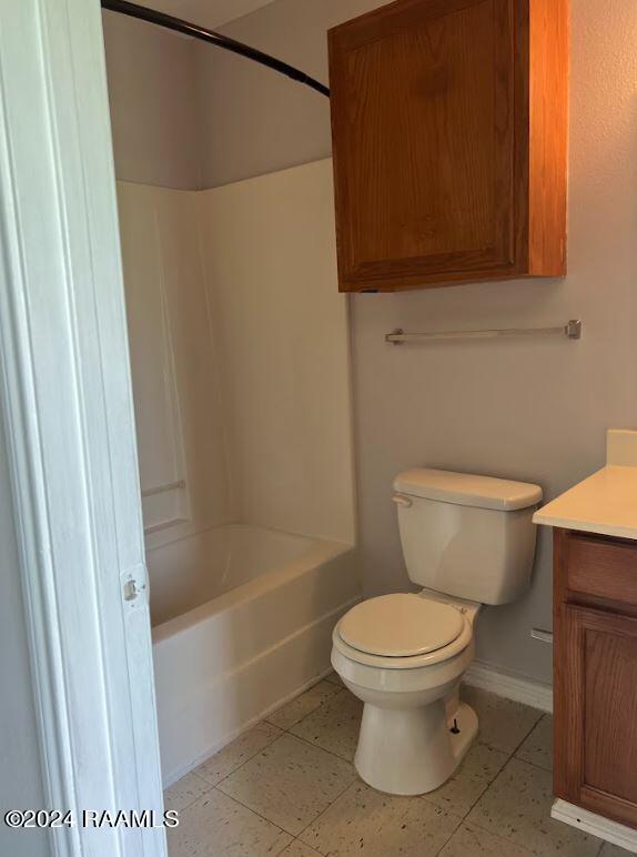 full bathroom featuring vanity, toilet, washtub / shower combination, and tile patterned floors