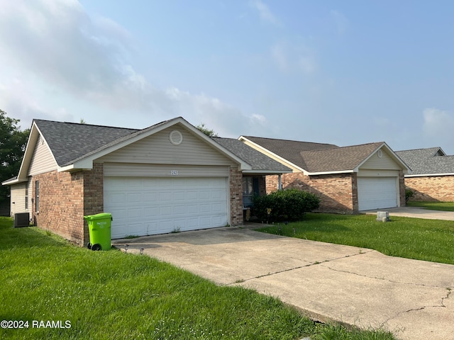 single story home featuring a garage and a front yard