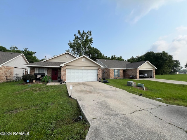 single story home featuring a garage and a front lawn