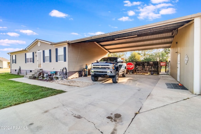 exterior space featuring a carport and a lawn