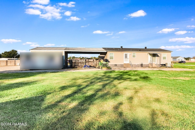 back of house with a yard and a patio