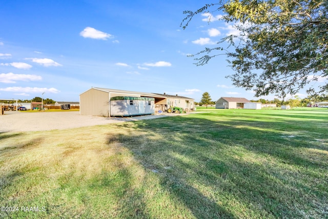 view of yard with a carport and an outdoor structure