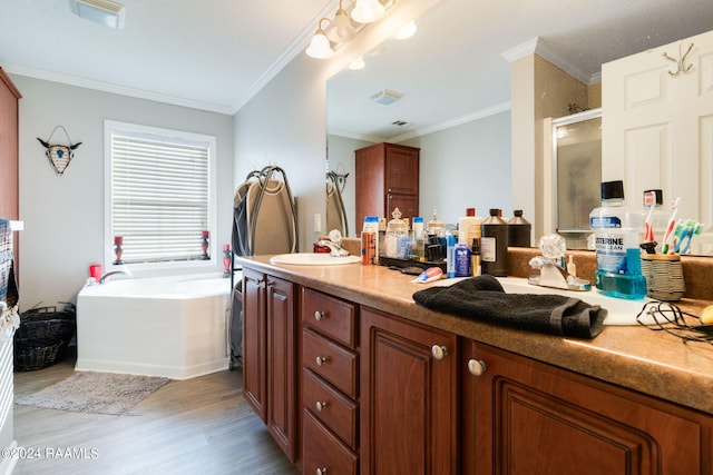 bathroom with ornamental molding, vanity, plus walk in shower, and hardwood / wood-style floors