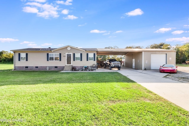 view of front facade with a garage, a carport, and a front lawn