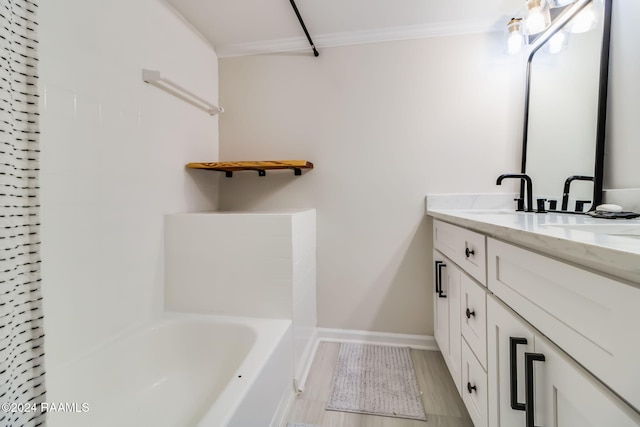 bathroom featuring baseboards, ornamental molding, and vanity