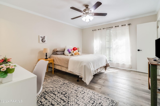 bedroom with ornamental molding, a ceiling fan, and wood finished floors