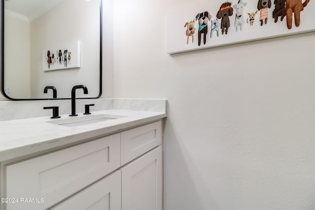 bathroom featuring ornamental molding and vanity