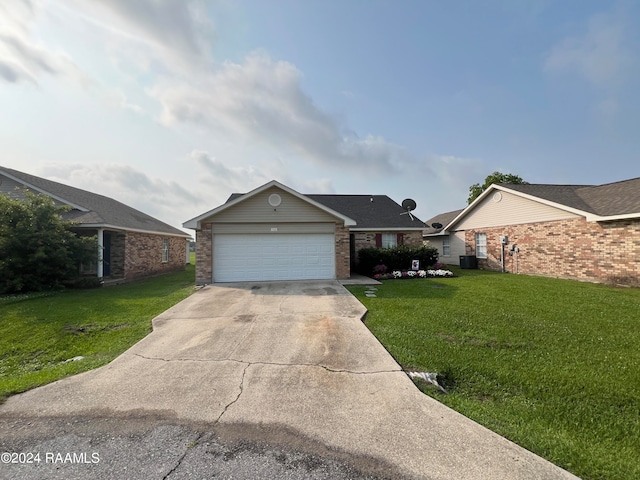 single story home featuring cooling unit, a garage, and a front lawn