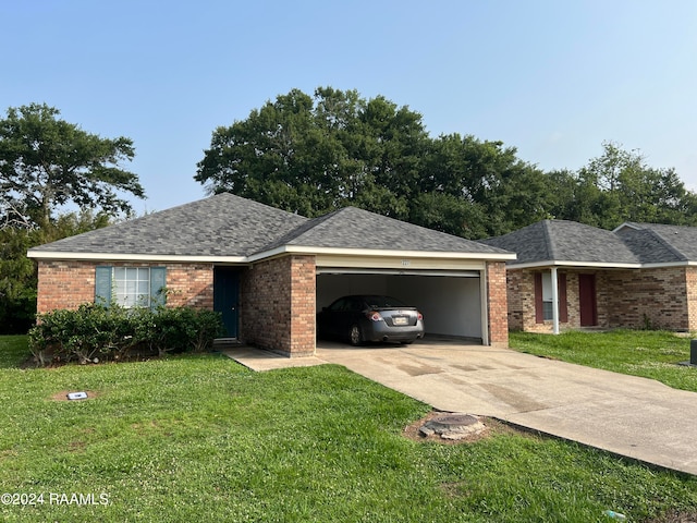 ranch-style home with a garage and a front lawn