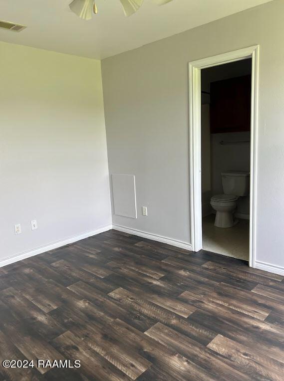 unfurnished room featuring ceiling fan and dark hardwood / wood-style floors