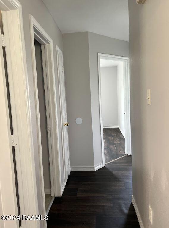 hallway with dark wood-type flooring