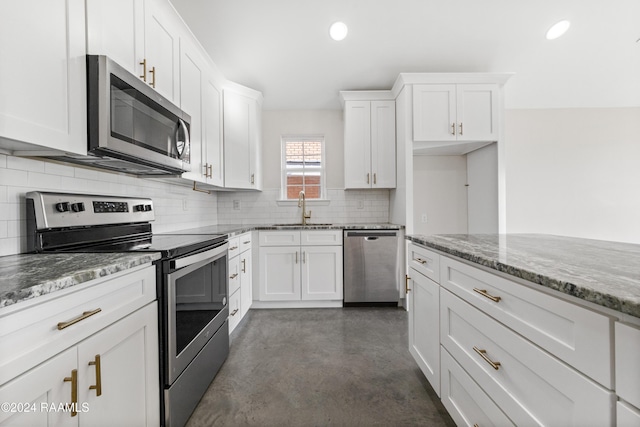 kitchen featuring backsplash, white cabinets, sink, light stone countertops, and stainless steel appliances