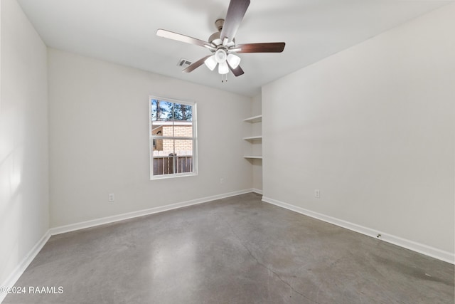 spare room featuring concrete floors and ceiling fan